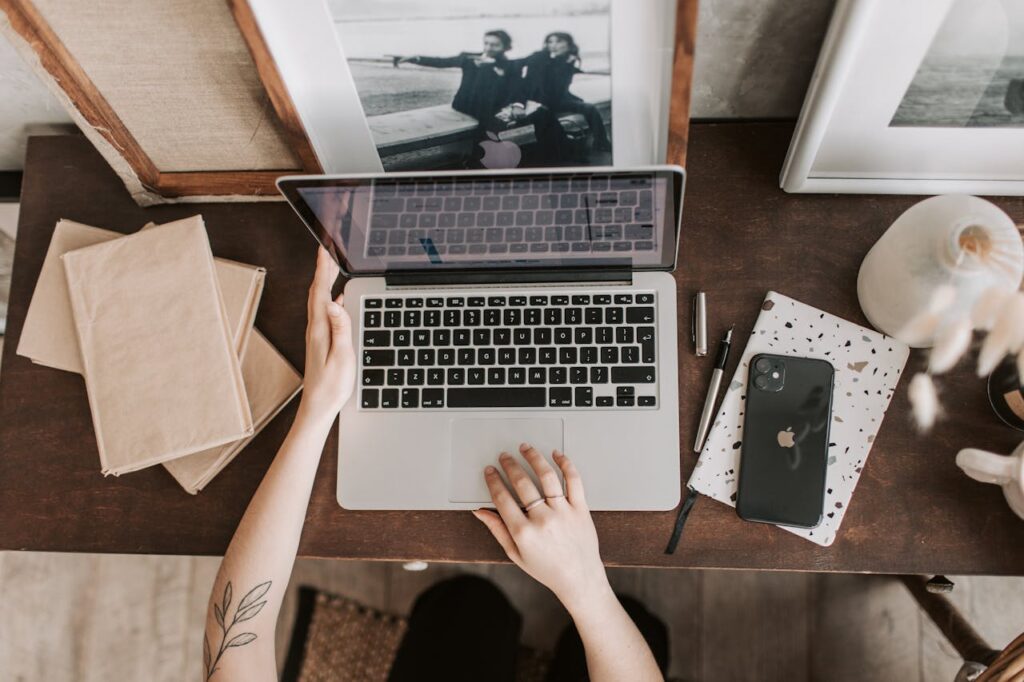 Unrecognizable lady using laptop in workspace